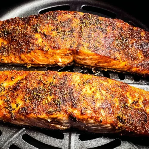 A freshly cooked Air fryer Salmon fillet on a plate.