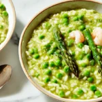 Creamy spring risotto served in a white dish, rich with seasonal produce.