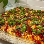 Overhead view of a delectable Salmon Sushi Bake ready to be served with nori sheets.