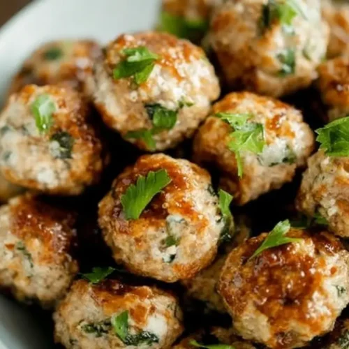 A serving of perfectly cooked ground turkey meatballs.