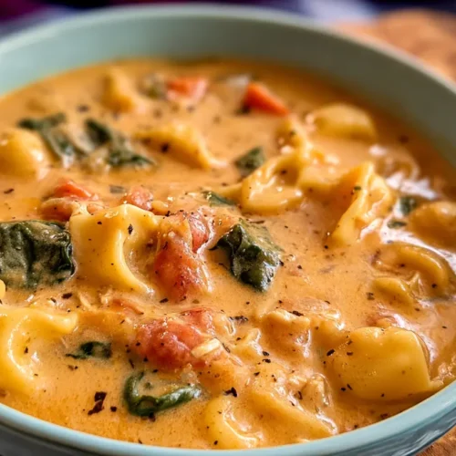 A warm bowl of creamy Marry Me Chicken Soup garnished with fresh herbs.