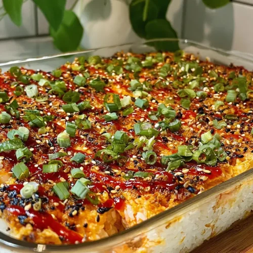A freshly prepared Salmon Sushi Bake in a baking pan, garnished with herbs.