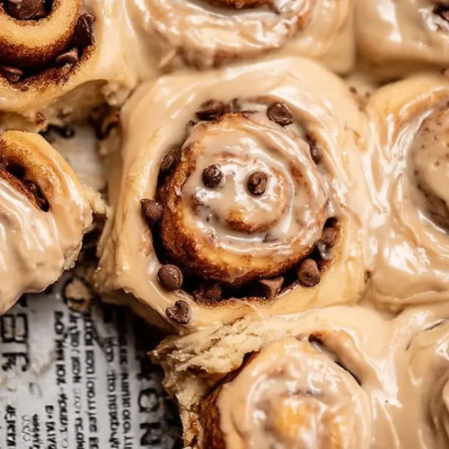 Freshly baked chai cinnamon rolls cooling on a wire rack
