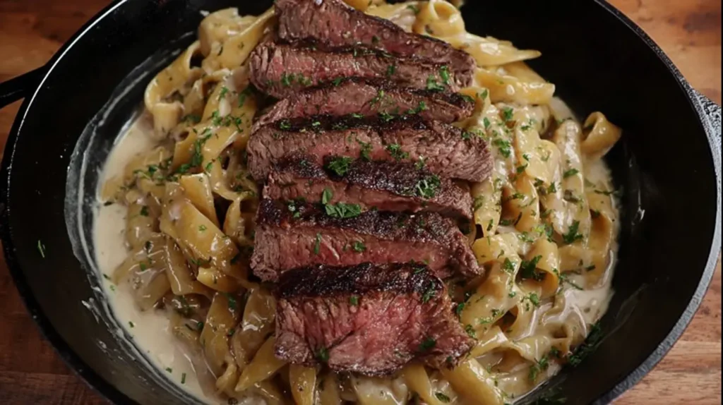 Indulgent creamy ribeye steak pasta on a dinner plate