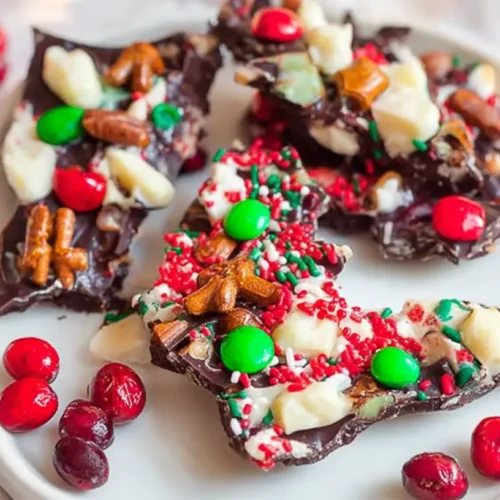 A close-up of colorful and festive Christmas bark, adorned with sprinkles and candies.