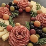 An artfully arranged charcuterie board featuring various Christmas party food items