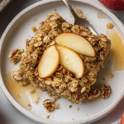 A steaming dish of oatmeal apple breakfast bake, fresh from the oven, ready to serve.