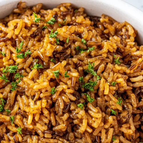 A bowl of Popeyes Cajun rice copycat recipe, rich in flavor and texture.