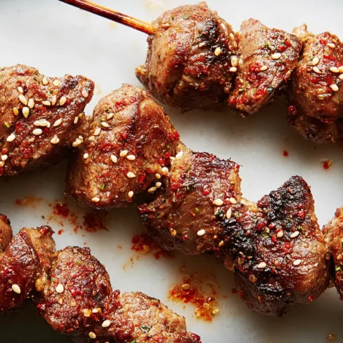 Close-up of spicy cumin chicken heart skewers, grilled to perfection
