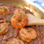 Close-up of voodoo shrimp, heavily sauced and garnished