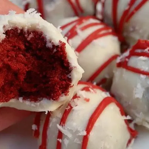 A plate of decadent cheesecake truffles, perfectly formed and dusted with cocoa.