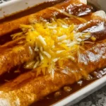 Delicious ground beef enchiladas baked to perfection with a rich red sauce.