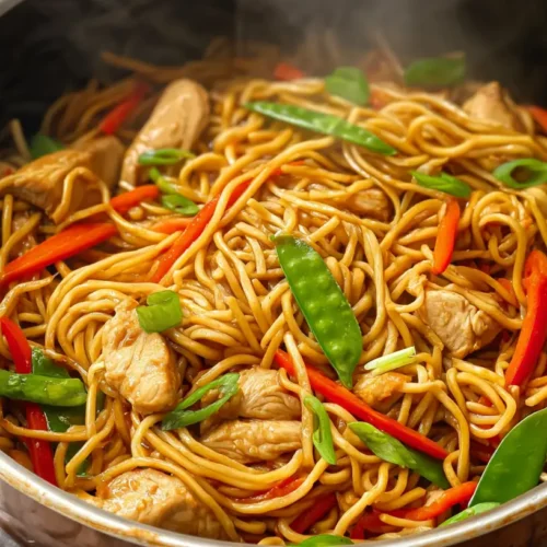 A vibrant bowl of chicken lo mein with tender chicken and fresh vegetables.