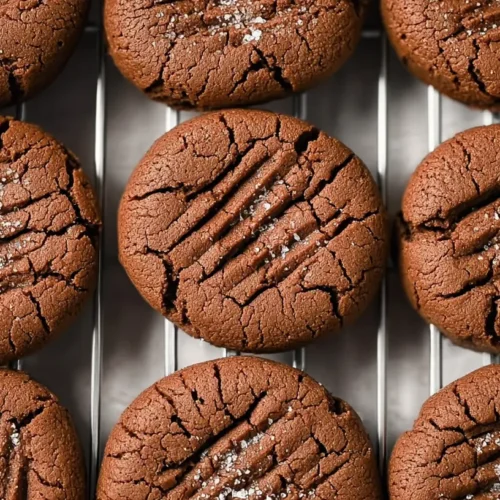 A close-up of delicious chocolate butter cookies stacked on a plate