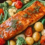 Delicious maple glazed salmon and mixed veggies cooked on a single pan.