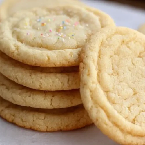 A freshly baked batch of easy sugar cookies on a cooling rack.