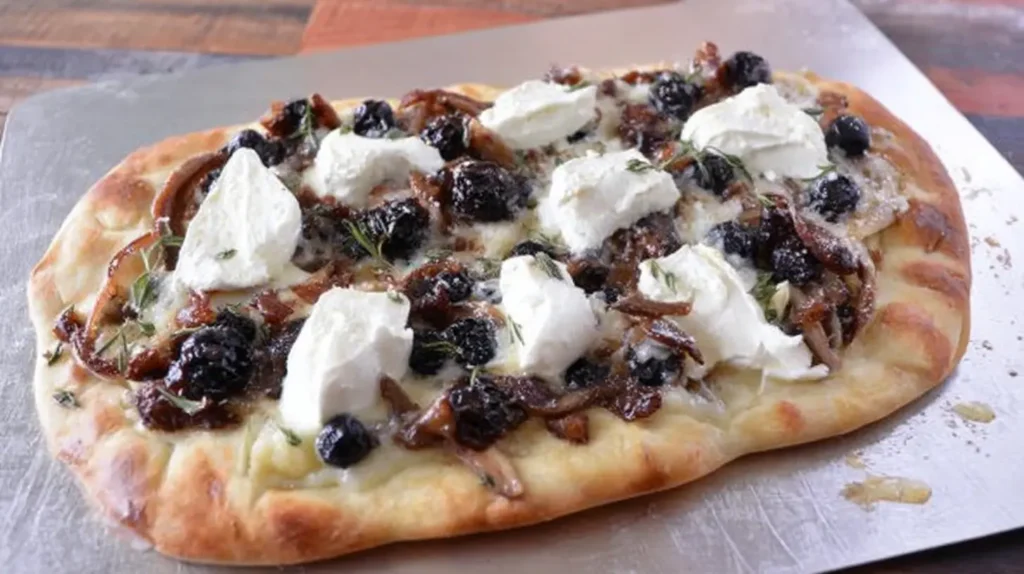 A platter of crispy flatbread featuring creamy brie and tart cranberries