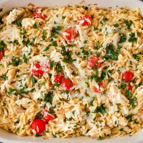 A steaming French Onion Chicken Orzo Casserole, freshly baked and bubbling.