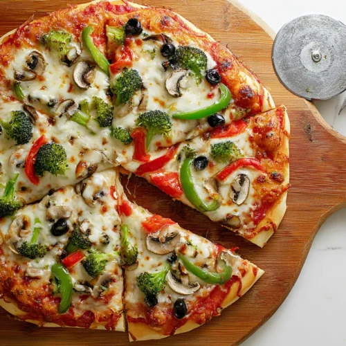 A freshly baked vegetable pizza topped with vibrant vegetables.
