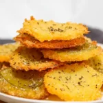 A close-up of crispy pickle cheese bites, perfectly fried
