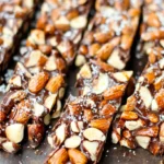 Several dark chocolate and sea salt nut bars arranged on a platter, ready for serving.