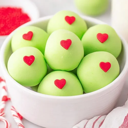 Bright green Grinch Oreo truffles, heart-topped