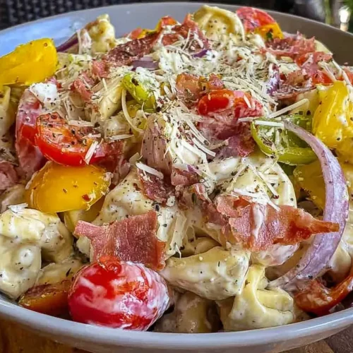 A vibrant Grinder Tortellini Salad filled with colorful ingredients.