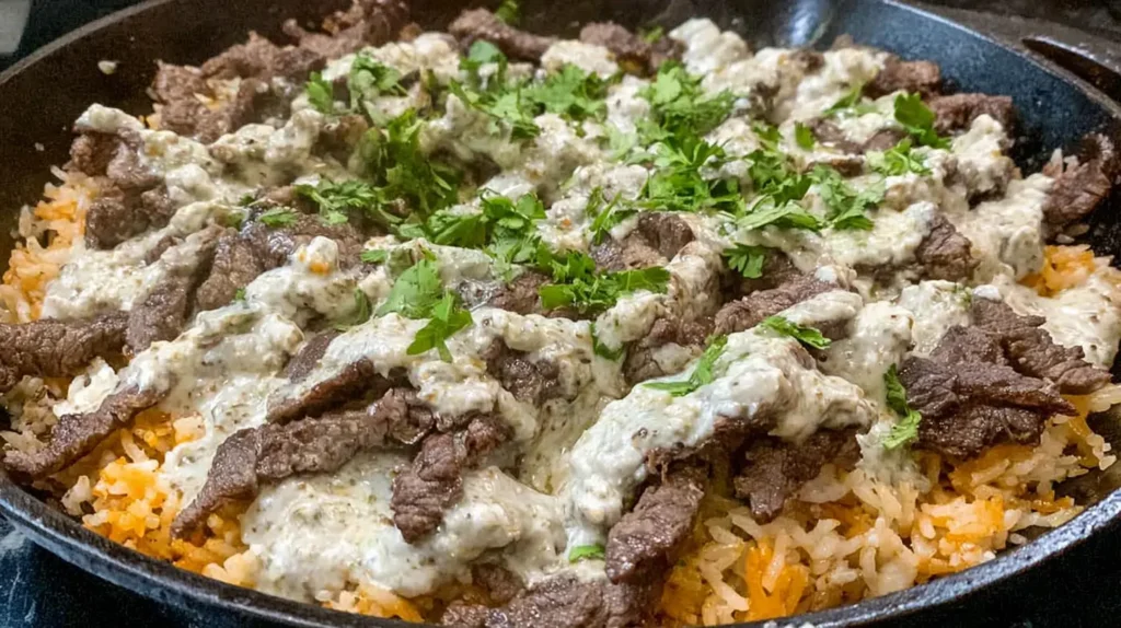 Hearty Steak and Cheese Rice, served hot in a ceramic bowl.