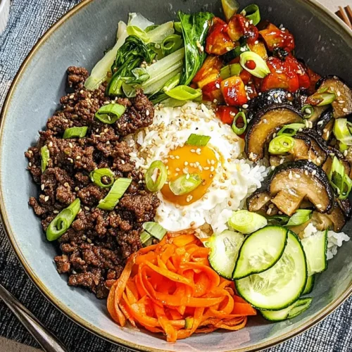A vibrant Korean beef bibimbap bowl with assorted colorful vegetables