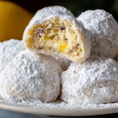 Delicious Lemon Cream Snowball Cookies dusted with powdered sugar