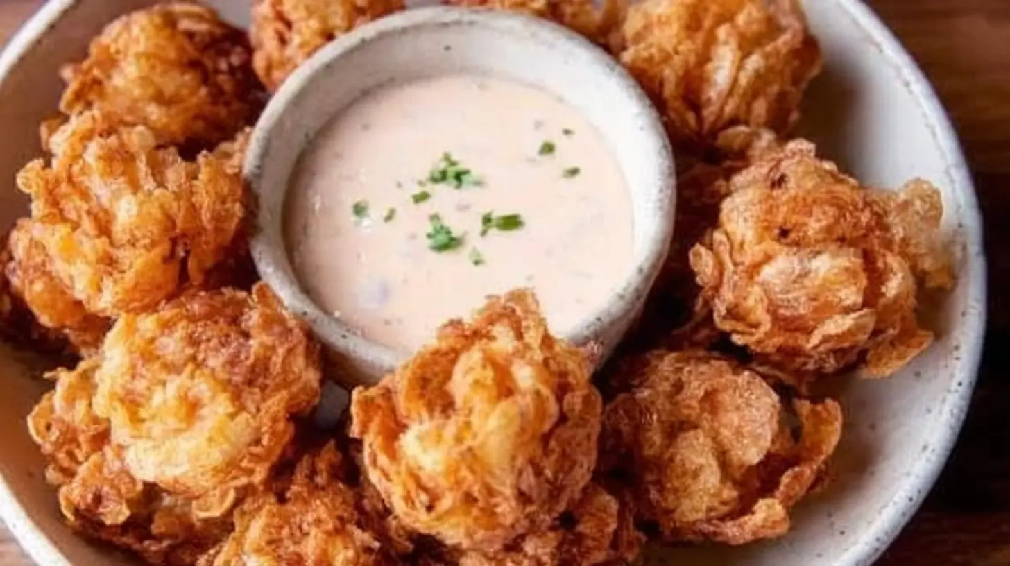 A platter of mini blooming onions served with creamy ranch