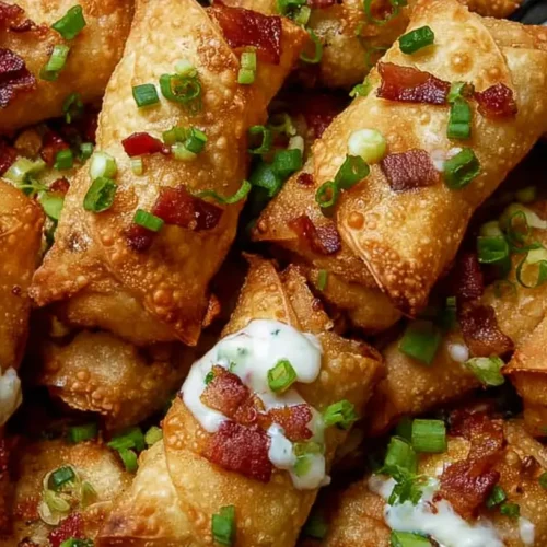A platter of golden-brown Mini Jalapeno Popper Egg Rolls, ready to be served.