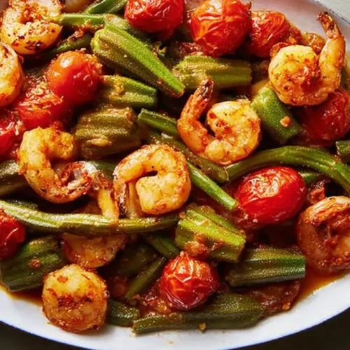 A close-up of Smothered Okra with Shrimp and Tomatoes in a rustic bowl.