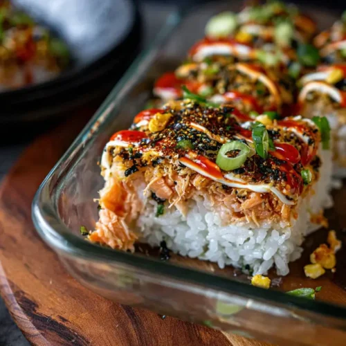 A delicious spicy salmon sushi bake in a casserole dish