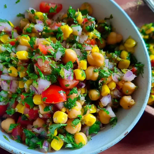 A colorful, healthy veg salad with chana as its base, presented in a large bowl.
