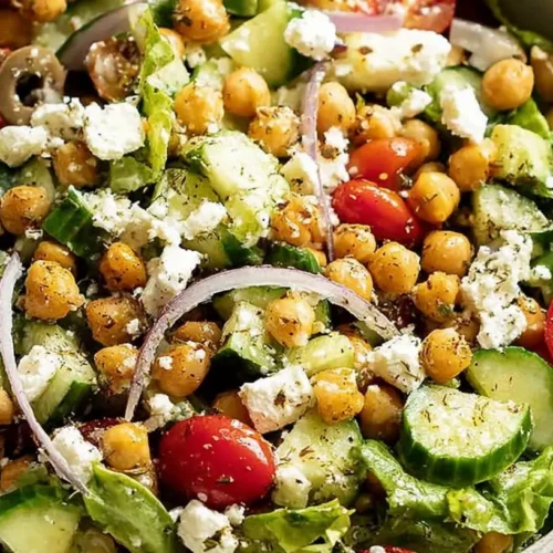 A vibrant Chickpea Greek Salad Bowl with feta, olives, and lemon oregano dressing.