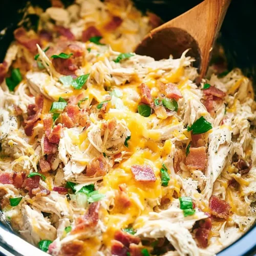 A bubbling crockpot chicken casserole in a slow cooker.