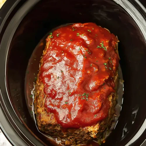 A juicy Crockpot meatloaf, cooked to perfection, sliced and ready to serve.