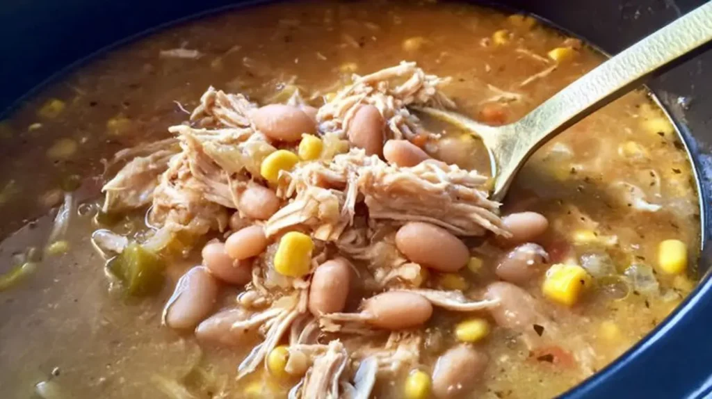 Creamy Crockpot healthy white chicken chili served in a ceramic bowl with tortilla chips.