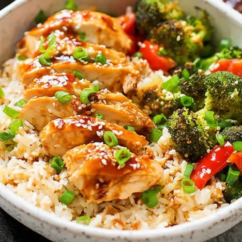 A baking dish filled with Dump-and-Bake Teriyaki Chicken and Rice, cooked to perfection.