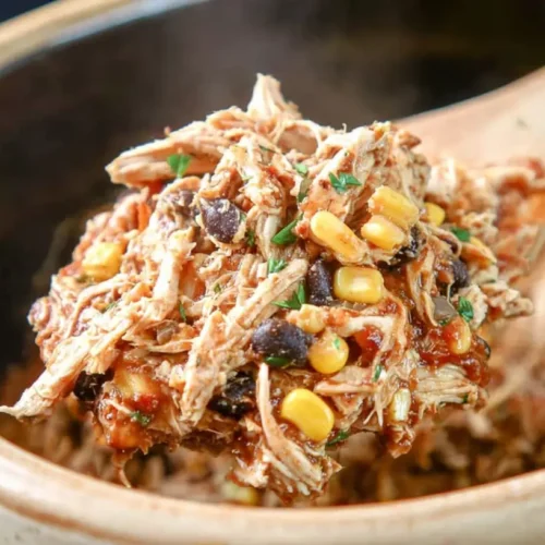 A bowl of easy crockpot shredded chicken, ready to serve.