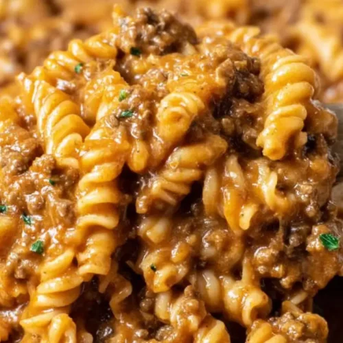 A bubbling hot ground beef pasta bake fresh from the oven, topped with melted cheese.