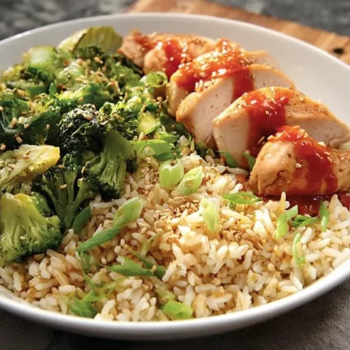 A vibrant healthy dinner recipe featuring rice and assorted vegetables in a bowl.
