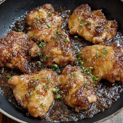 A close-up of perfectly glazed honey garlic chicken thighs