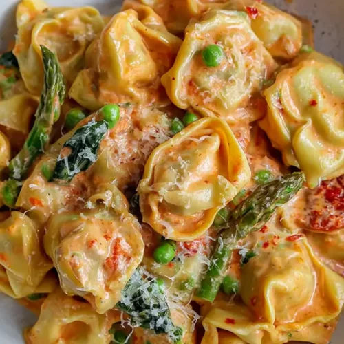 A serving of one-pot creamy garlic parmesan tortellini in a pan, no draining required for this easy recipe.