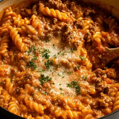 A hearty one-pot ground beef pasta dish simmering in a skillet.