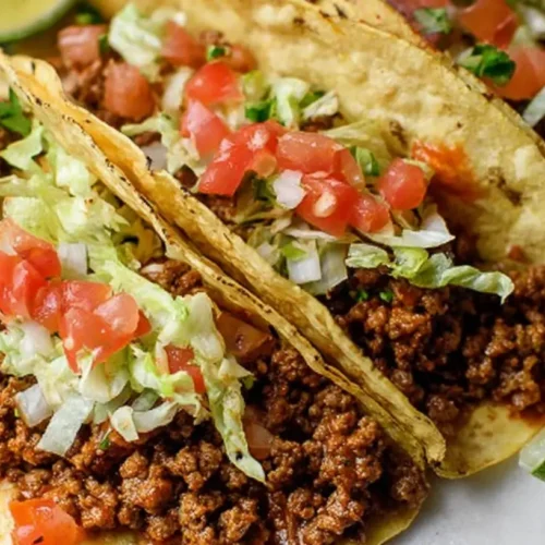 A plate of quick ground beef tacos with fresh toppings.