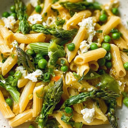 A vibrant bowl of spring veggie pasta dinner with fresh seasonal vegetables.