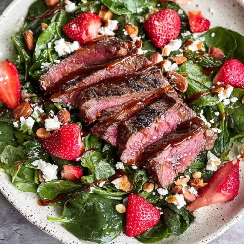 Grilled steak and fresh strawberry spinach salad with balsamic dressing
