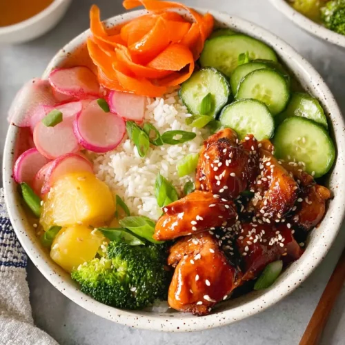 A vibrant teriyaki chicken salad bowl with fresh greens and grilled chicken